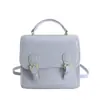 Mochila de alta gama estilo academia con doble hebilla 2026 Nueva moda Bolso de mano versátil Bolso de hombro con relieve para el trabajo