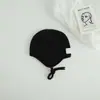 Gorro de lana tejido con protección para los oídos para niños y bebés, transfronterizo, con etiqueta de tela elegante, correas de colores caramelo para niños y niñas