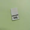 Etiquetas de Talla en Stock al por Mayor Planas de Doble Tejido Etiquetas de Origen con Letras Entrega Directa de Fábrica Accesorios Universales para Ropa