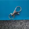 Fabricante de hebillas para perros al por mayor, ganchos para mascotas de aleación de zinc, hebillas de placa de resorte para bolsas de ferretería y ganchos en forma de oliva grandes y pequeños en stock