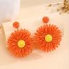 Aretes de flores de color estilo festivo transfronterizo europeo y americano, aretes de rafia tejidos a mano simples de alta gama para verano