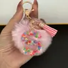 Suministra y Vende Llaveros con Alfabeto de 26 Letras en Forma de Corazón de Colores con Pompoms y Borlas, Colgantes para Llaves para Bolsos de Mujer