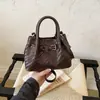 Bolso tejido de patrón de alta gama transfronterizo de nicho para mujer, nuevo bolso cruzado versátil de moda 2026, bolso de mano tipo cubo