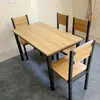 Fabricante directo de mesas y sillas para comedores de comida rápida, muebles de acero-madera-hierro, una mesa con cuatro sillas, para uso doméstico, tiendas de té de leche, cafeterías, restaurantes sencillos, venta al por mayor