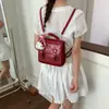 Mochila de alta gama estilo academia con doble hebilla 2026 Nueva moda Bolso de mano versátil Bolso de hombro con relieve para el trabajo