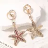 Llavero de Estrella de Mar con Pedrería de Cristal Estilo Marino Aro de Metal Completamente Cubierto de Pedrería Encanto para Bolso Estilo Femenino Pequeño Regalo
