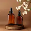 Venta al por mayor de fábrica Botella de loción color té Botella con hombro inclinado Spray Botella de perfume Aceite esencial Botella de vidrio cosmético Soporte Impresión UV