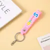 Acessórios de chaveiro fofos PVC borracha macia alça portátil letras corda de couro inglês chaveiro pingente de boneca corrente
