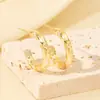 Pendientes Metálicos Populares de Lujo Transfronterizos Europeos y Americanos con un Toque de Alta Gama, Pendientes de Botón Florales Transfronterizos de Nicho