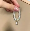 Mini Labubu Cuarta Generación Caja Sorpresa Ropa de Muñeca Collar Colgante Labubu 26 Letras Collar de Perlas Accesorios de Joyería