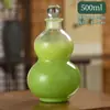 Botella de calabaza roja neta de 500 ml botella de té de lugar escénico botella de vidrio transparente botella de té con leche de medicina tradicional china con logo de cuerda de mano