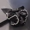 Accesorios para el cabello nuevos de primavera y verano al por mayor Anillo para el cabello con lazo de organza Cuerda para la cabeza simple para mujer Banda de goma Cubierta de cuero
