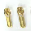 Um grande número de ouro de alta qualidade spot Não. 5 metal com puxador de trava dourado puxador de zíper de mala peça de zíper