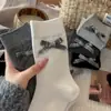 Novas meias femininas de outono e inverno com laços grandes, meias caneladas de cor sólida até o meio da panturrilha, sem costura e versáteis, meias cinzas estilo coreano