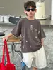 Tienda de Algodón Ropa de Verano para Niños Camiseta Versátil de Manga Corta para Niños 2026 Nuevo Estilo Coreano Resistente de Moda Lavada Moda Infantil
