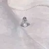 Pendientes de botón con colgante de perla de Saturno y circonita microincrustada francesa, elegantes, de acero de titanio de alta calidad, para el lóbulo de la oreja, al por mayor