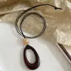 Estilo Harajuku ~ Collar con Colgante Ovalado Cortado en Cuerda de Cuero Negro para Mujer 2025 Nuevo Diseño de Nicho Cadena para Suéter Estilo Étnico