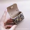 Llavero de Bolso Retro Francés Pu Estampado Leopardo Bolso Mini Portátil Moda Colgante Cabeza de Bolso Bolso para Auriculares Billetera