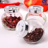 Venta al por mayor, botella de vidrio plana de 180 ml, para especias, miel, mermelada, caramelos, té, semillas y flores.