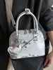 2025 Nueva Moda Tendencia Diseño Nicho Bolso de Concha de Mano Estilo Coreano Estilo Extranjero Versátil para Viajes al Trabajo Crossbody Bolso de Mujer