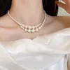 Joyas de collar colgante de cadena para clavícula de lujo ligero de alta gama de nicho, accesorios de perlas de moda, collar de mariposa de nicho versátil al por mayor