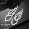 Joyería de comercio exterior aretes brillantes de diamantes completos cadena de doble garra strass aretes para discoteca fabricantes venta al por mayor aretes E804