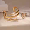 Conjunto de Joias Europeu e Americano Quente e de Venda Cruzada com Design Largo Espiral Geométrico, Sensação Elegante e Luxuosa, Anel e Pulseira para Mulheres