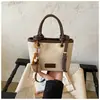 2026 Bolso tote tipo cubo de moda coreana ins, moderno, simple, versátil, casual, bolso de mano, bolso de hombro cruzado para mujer