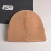 2022 nuevo gorro de punto con volantes de color liso para mujer, gorro de invierno de otoño e invierno, gorro de lana cálido de comercio exterior, combina con todo