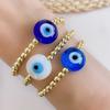 Amazon Europa y Estados Unidos personalidad popular ojo de diablo esmalte de color cuenta plana pulsera 18K cobre chapado en oro cuentas pulsera elástica mujer