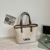 Bolsa de lona de gran capacidad para mujer, nueva bolsa de mano de moda casual Otoño 2026 para la escuela y el trabajo, bolso de cubo de mano