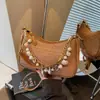 Bolso de axila tejido de diseño de nicho transfronterizo para mujer, nuevo bolso de hombro versátil casual de verano 2026, bolso cruzado de nicho