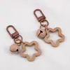 Llavero con Colgante de Campana de Estrella de Cinco Puntas de Colores Caramelo de Aleación Cubierta para Auriculares Decoración de Pareja