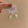 Pendientes de bola de metal cepillado esmerilado de temperamento único de nicho 2025 nuevos populares para otoño e invierno sensación de lujo ligero de alta gama