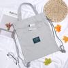 Mochila de Lona Estilo Novo 2026 para Estudantes do Sexo Feminino, Bolsa de Ombro Criativa com Cordão de Uso Duplo e Bolsa de Cordão