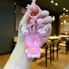 Llavero acrílico con forma de botella de arenas movedizas en aceite, regalo al por mayor, colgante de muñeca de donut, lindo llavero de arenas movedizas.