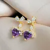 Pendientes de Cobre Dorado con Circonitas en Forma de Corazón Brillantes Blancos y Morados para Mujer 2026 Nuevo Estilo Pendientes de Alta Gama Pendientes Únicos y Hermosos