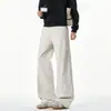 Pantalones de trabajo negros de pierna recta para hombre, de corte diagonal, estilo retro americano, pantalones casuales de moda y holgados con un diseño de pierna ancha y fluida.