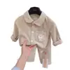 Conjunto de pijama cepillado para niños, nueva colección otoño 2026, manga larga, diseño de cuadros de dibujos animados, unisex, con cuello camisero, adecuado para ropa de casa