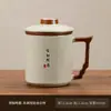 Taza de té de cerámica en caja de regalo de horno Ru, vaso de agua personal para la oficina, taza con tapa, filtro de separación de té y agua, regalo