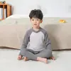 Conjunto de ropa interior térmica de manga raglán para niños 26 Otoño/Invierno para niños y niñas, conjunto de dos piezas de pijama y pantalón de dormir de cuello redondo para niños