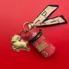 Bolsa cilíndrica de couro popular Shuibei em ouro 999 puro com pingente de cordeiro da sorte, presente promocional de luxo infundido com ouro para o Ano Novo