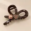 Pinza de pelo pequeña con garra para temperamento de princesa, pinza de pelo lateral estilo coreano exquisita, sensación de alta gama, nuevo pinza de pelo para media coleta 2026