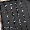 Nuevos y modernos aretes de cruz con diamantes completos Jiuhan para mujer, ear cuffs de acero de titanio de nicho, populares tachuelas de hueso de la oreja de alta gama