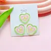 Nuevo fresco botón de amor de cuatro agujeros accesorios diy ropa de niños accesorios de botón de abrigo corazón de melocotón multicolor venta al por mayor
