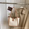 Bolsas de mano para mujer transfronterizas, nuevo modelo 2026, bolso de hombro y bandolera de alta gama a la moda para mujer, bolso de mano simple para el día a día, bolso tipo cubo
