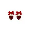 Pendientes de plata con aguja, aceite, lentejuelas rojas, corazón y lazo. Pendientes retro de nicho. Pendientes de moda exquisitos para mujer.