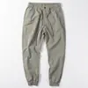 Venta al por mayor transfronterizaPantalones casuales finos de seda helada de verano para hombre Pantalones japoneses simples con tobillo atado elástico Pantalones cargo holgados
