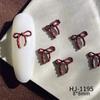 Nuevos accesorios de arte de uñas con pintura en aerosol de aleación, accesorios de arte de uñas de la suerte de Año Nuevo rojo de otoño e invierno, lazos huecos conjoined