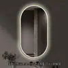 Espelho de banheiro inteligente oval em estoque com polimento externo e iluminação LED translúcida, adequado para montagem na parede do banheiro e projetos de hotel, com opções de personalização